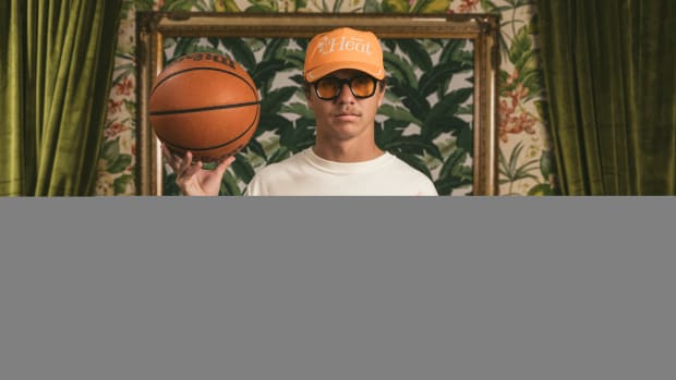 A model wears white and orange Duvin apparel.